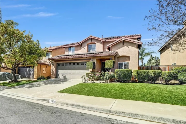 Inviting exterior with mature landscaping and covered entry