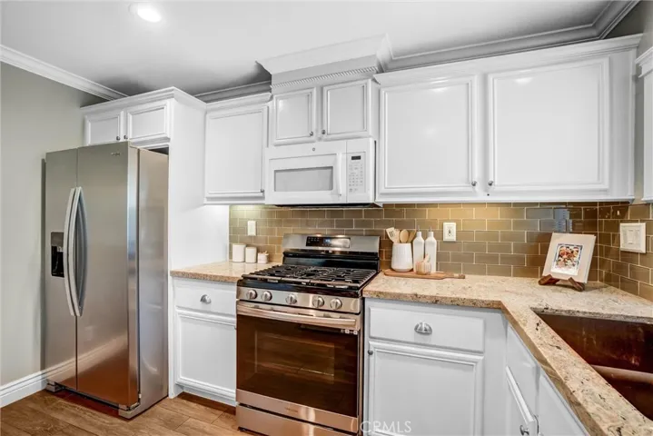 Functional kitchen layout with stainless steel appliances and abundant storage