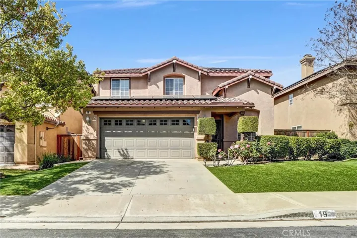 Beautifully maintained two-story home with charming curb appeal, manicured landscaping, and a spacious driveway