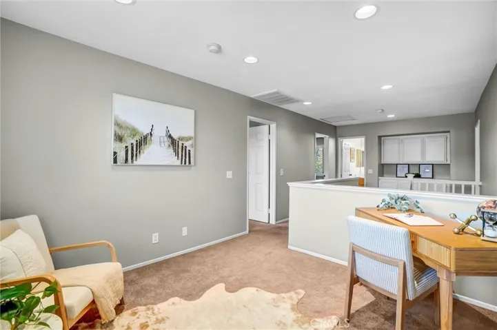 Open upstairs loft providing additional living or workspace with abundant natural light