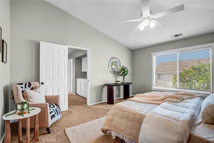 Bright primary suite with large windows and comfortable layout for relaxation
