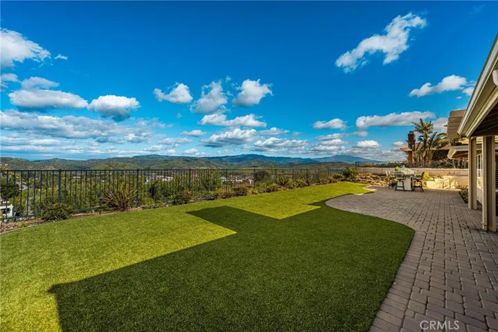 Lush turf and warm brick pavers throughout