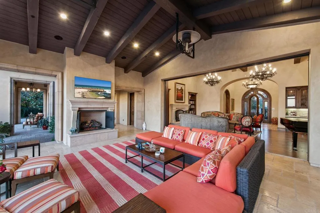 This large covered room off the great room boasts, over head heaters and fireplace to gather.