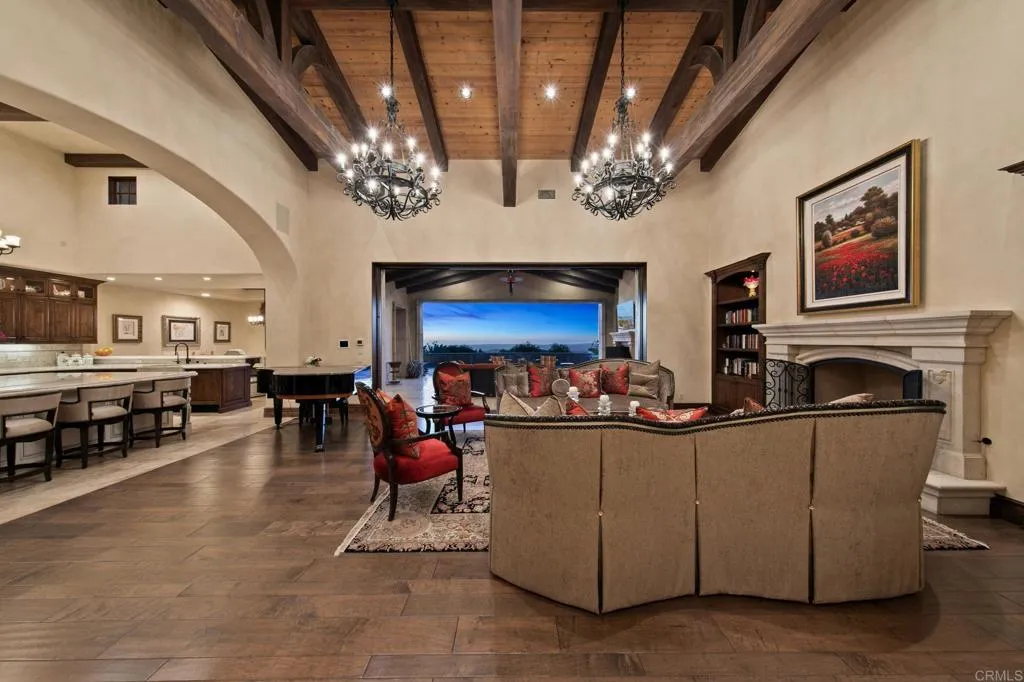 Spacious entertaining area with built out book cases and vanishing slider doors.