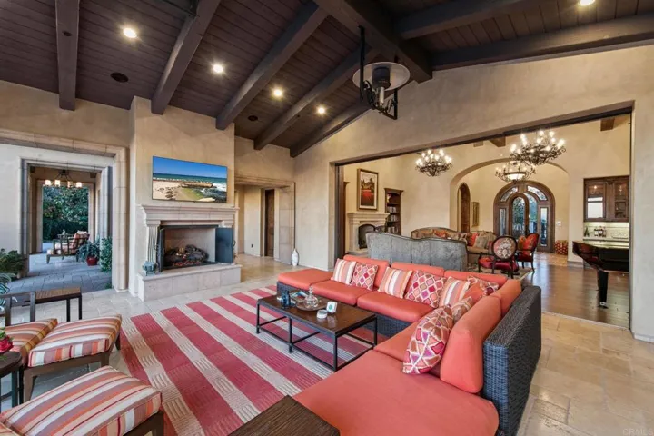 This large covered room off the great room boasts, over head heaters and fireplace to gather.