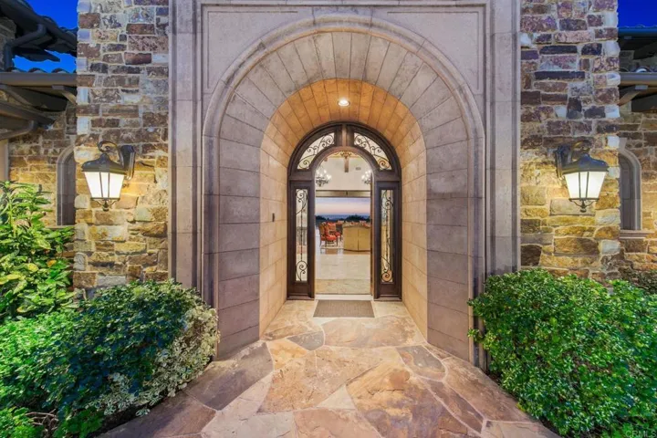 Open the double gates to the private courtyard leading to the handsome front door.