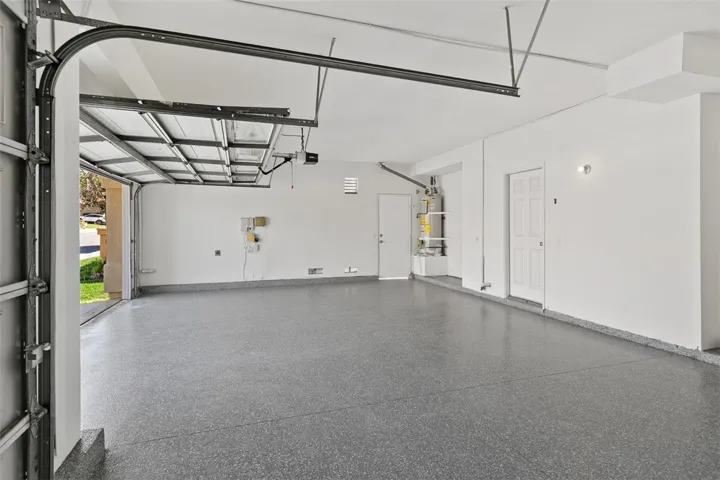 3 Car Garage Has Been Freshly Painted and Features a New Epoxy Floor