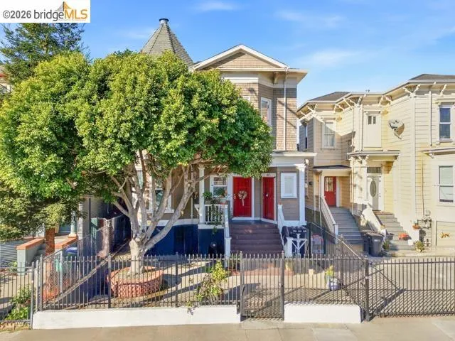 View of front facade featuring a fenced front yard and a gate