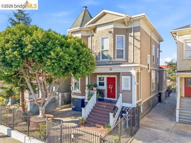 Victorian house featuring a fenced front yard and a gate
