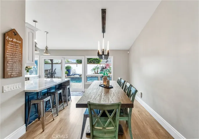 Spacious dining area with marble breakfast bar and views to the resort-style backyard