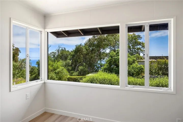 Upstairs bedroom 2 with great hillside views and peak ocean views. Could be primary bedroom.