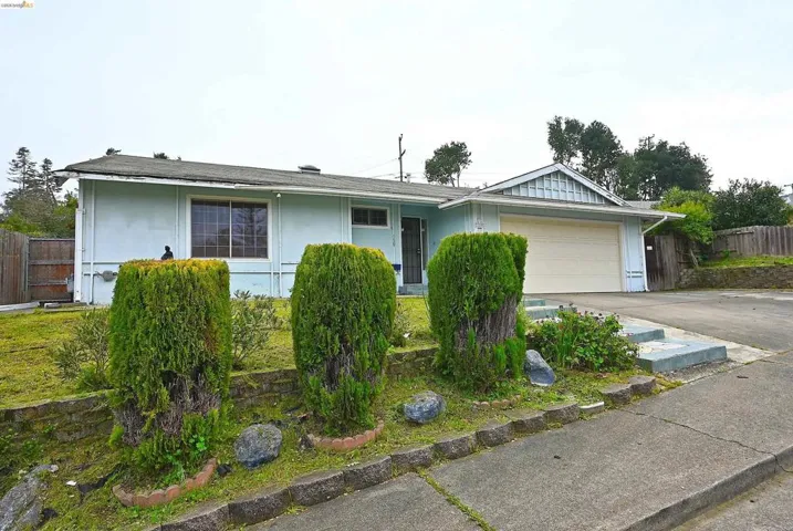 Single story home featuring an attached garage and driveway