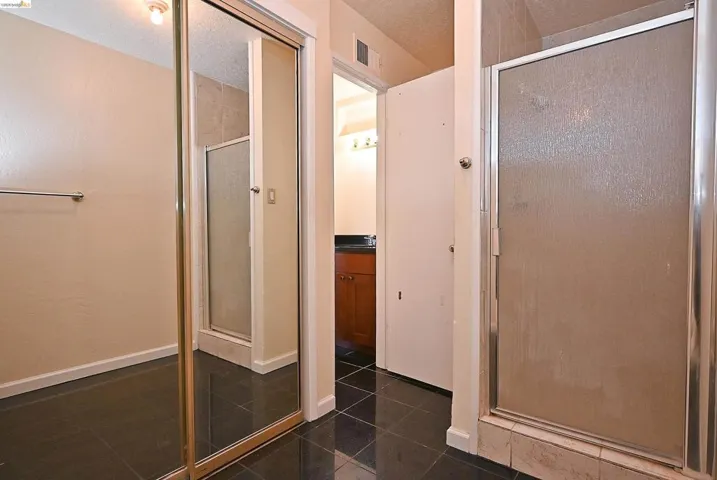 Bathroom featuring a stall shower and vanity