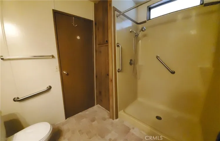 View of guest bathroom with walk in shower.