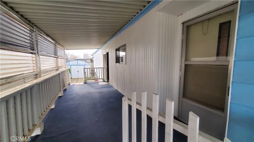 View of covered front porch with front entry door on the right.