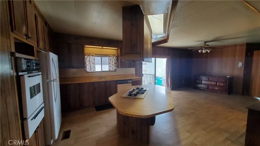 View of kitchen with island overlooking family room area.