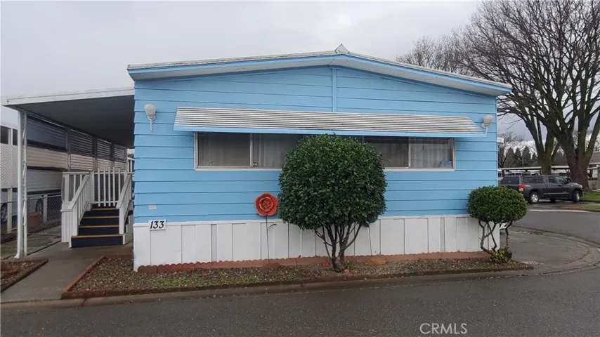 View of front with large, covered front porch with steps.