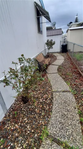 Back sidewalk behind home.