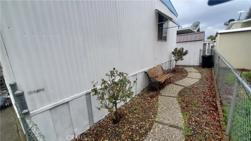 View of back yard walkway to shed.