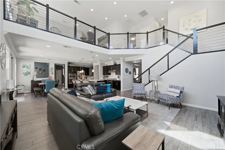 Open great room with modern staircase and loft.
