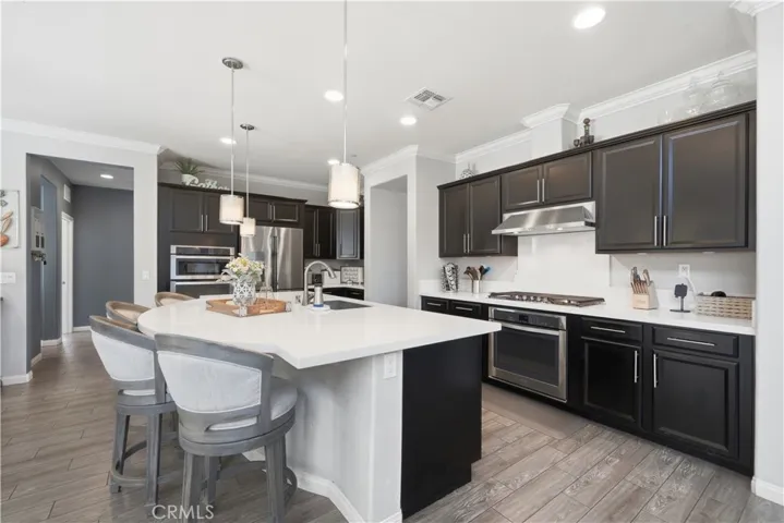 Kitchen with 2 ovens, quartz countertops and roomy island.