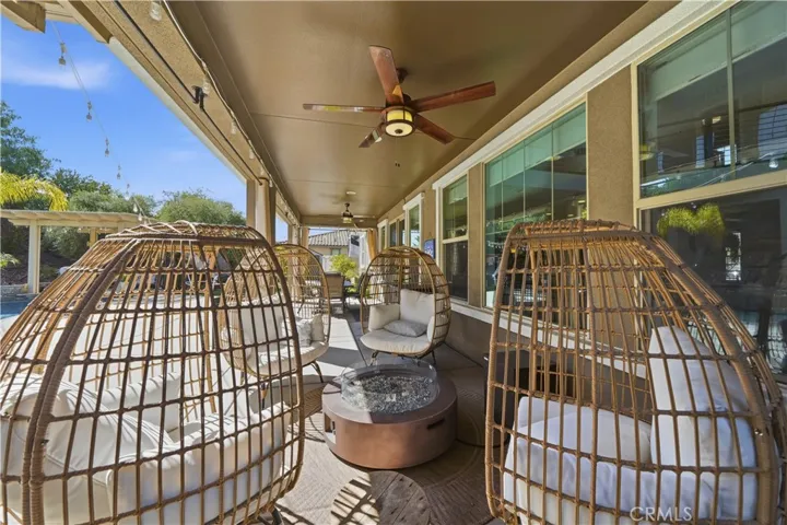 Seating under covered patio with fan.