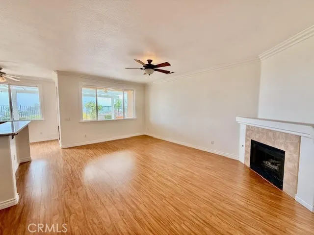 Living room shows natural lighting and fireplace