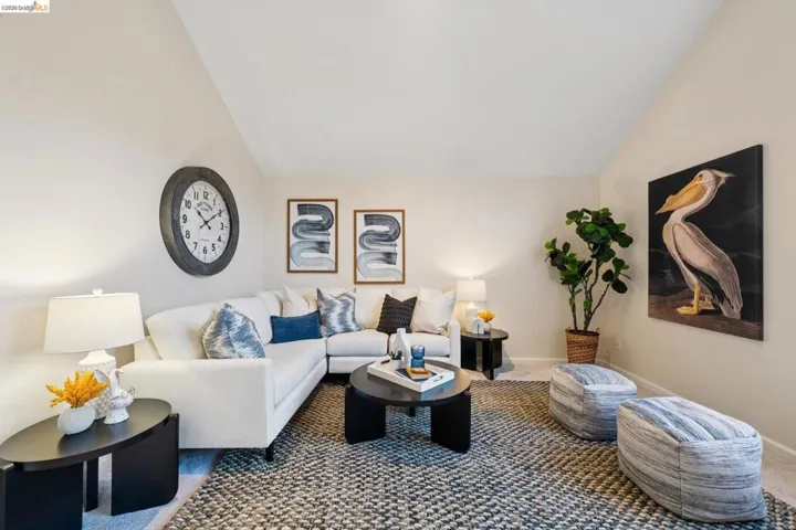 Carpeted living area featuring lofted ceiling
