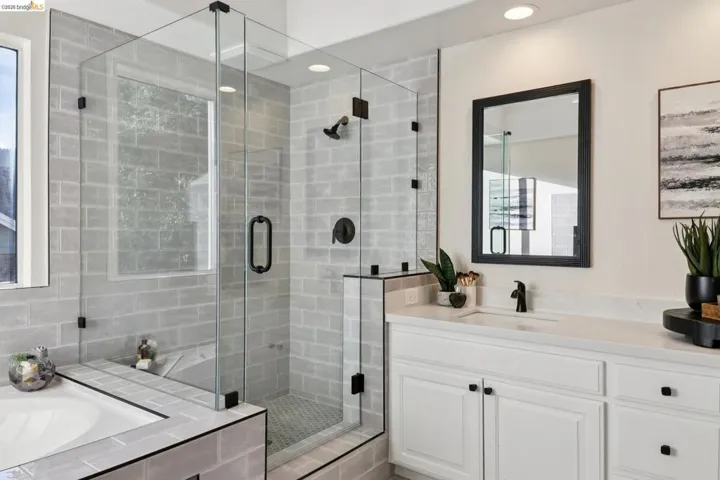 Full bath featuring a shower stall, vanity, and a bath