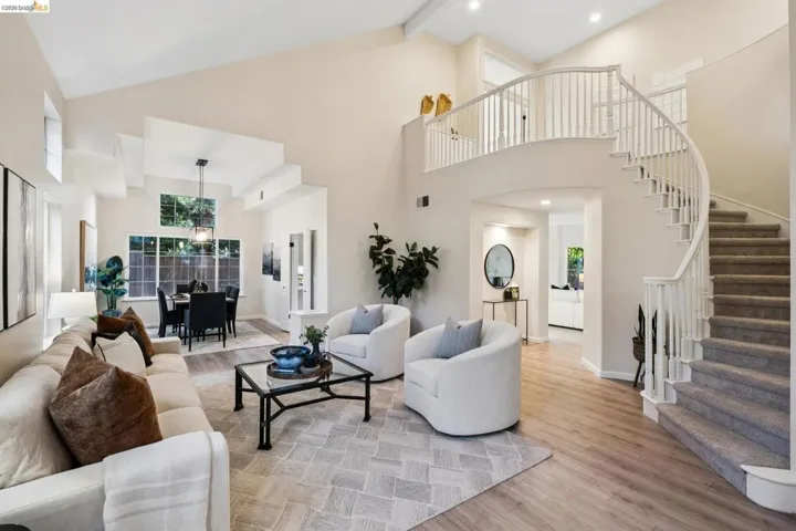 Living area featuring light wood-style floors, vaulted ceiling, and recessed lighting