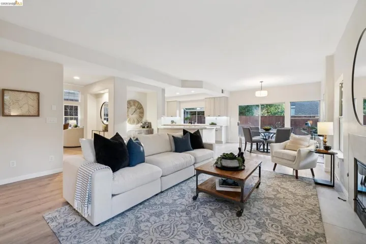 Living room featuring a tiled fireplace, light wood-style floors, and recessed lighting