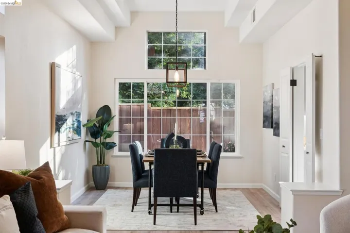 Dining area with wood finished floors and a high ceiling
