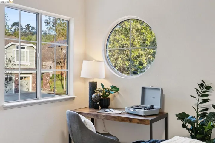 Home office with plenty of natural light and a textured wall
