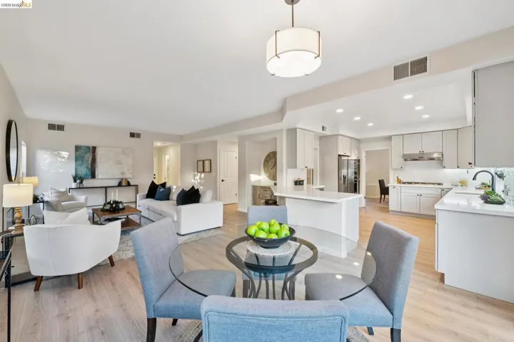 Dining space with light wood-style floors and recessed lighting