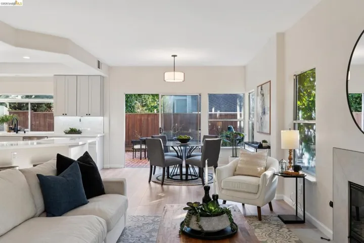 Living area with a glass covered fireplace and light wood finished floors