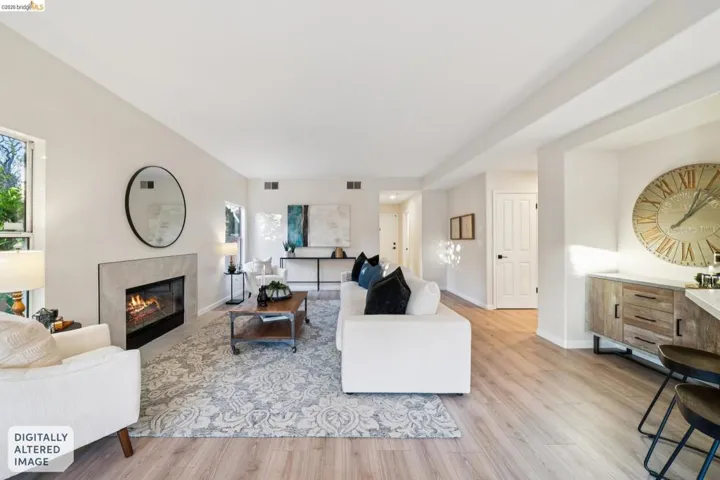 Living room featuring light wood-type flooring and a premium fireplace