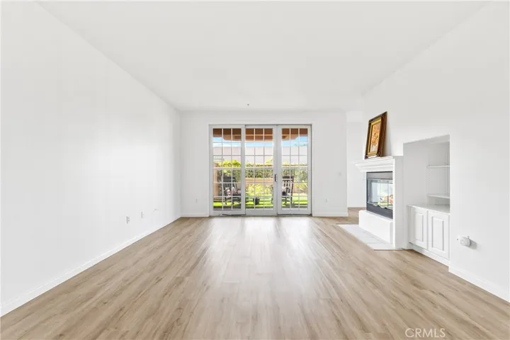 Nice spacious living room! It open onto your newly remodelled and landscaped wrap around patio.  The fireplace has been visually altered.