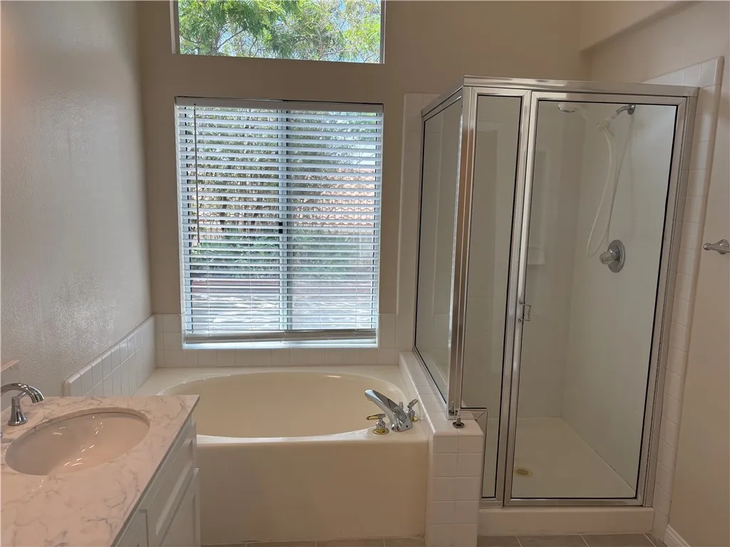 Primary Bathroom with tub and separate shower