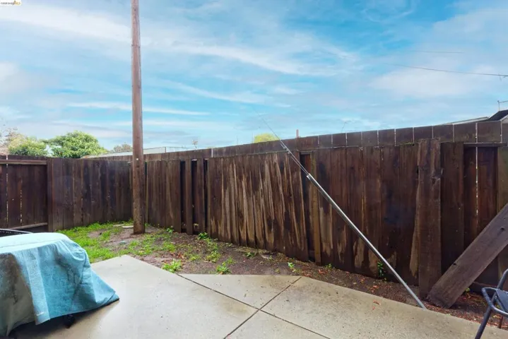 Fenced backyard with a patio area