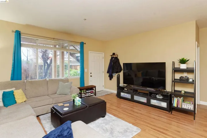 Living room featuring light wood-type flooring and baseboards