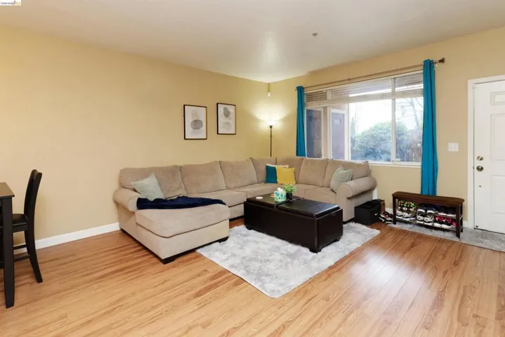 Living room with light wood-style floors and baseboards
