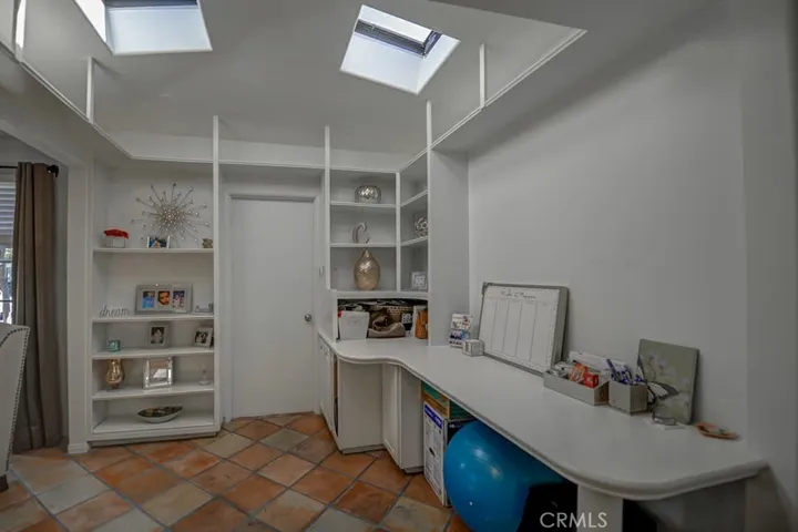 Office has shelves, desk and lots of storage