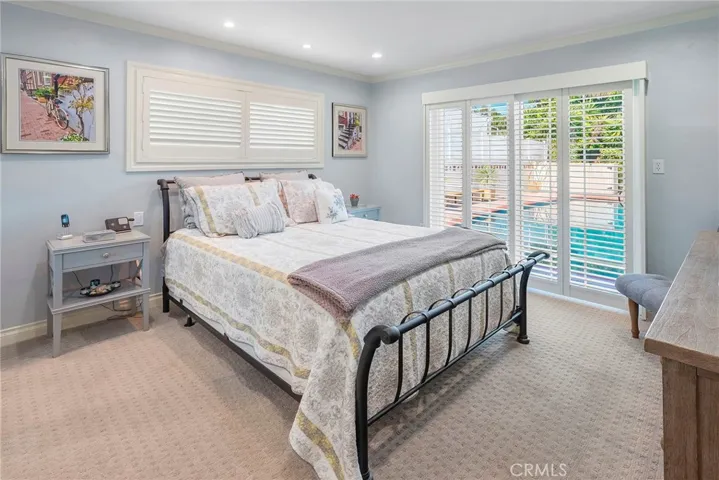 Primary bedroom with sliding glass doors to the backyard