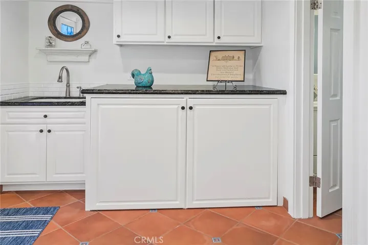 Hidden laundry area with utility sink