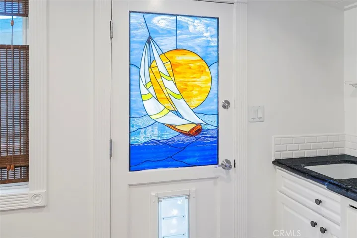 Stained glass back door with doggie door leading to side yard
