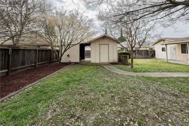 Mower carport/storage off of little shop/shed