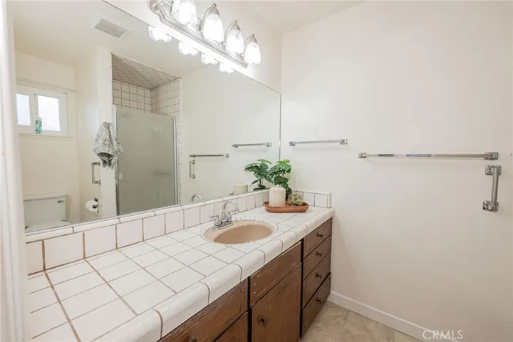 Primary Bathroom with shower & cabinets
