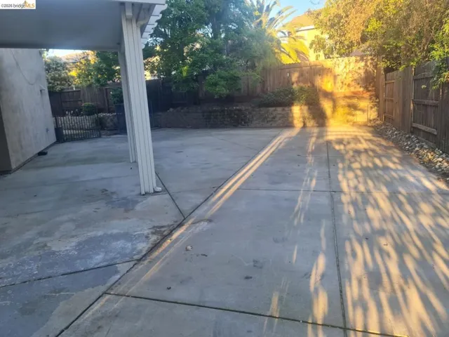 Fenced backyard with a patio