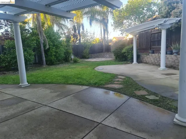 Fenced backyard with a patio and a pergola