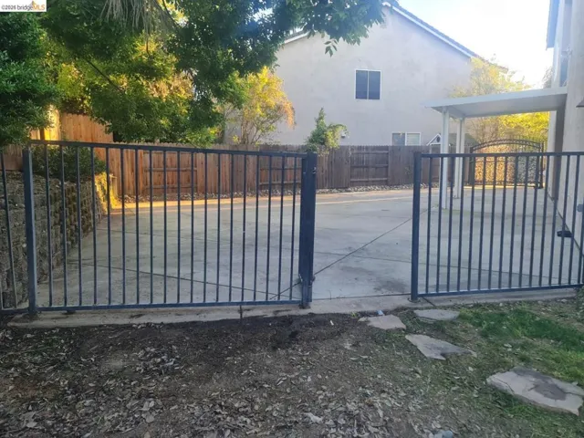 Gate featuring a patio